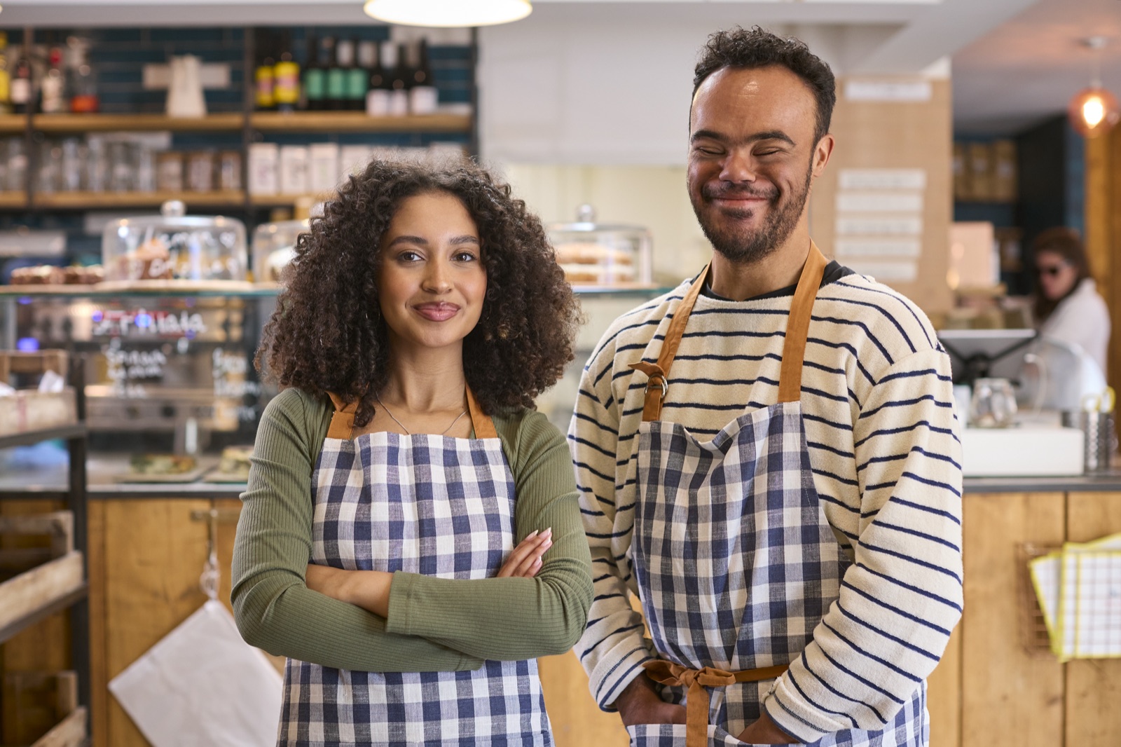 Two bakery owners standing together behind the counter