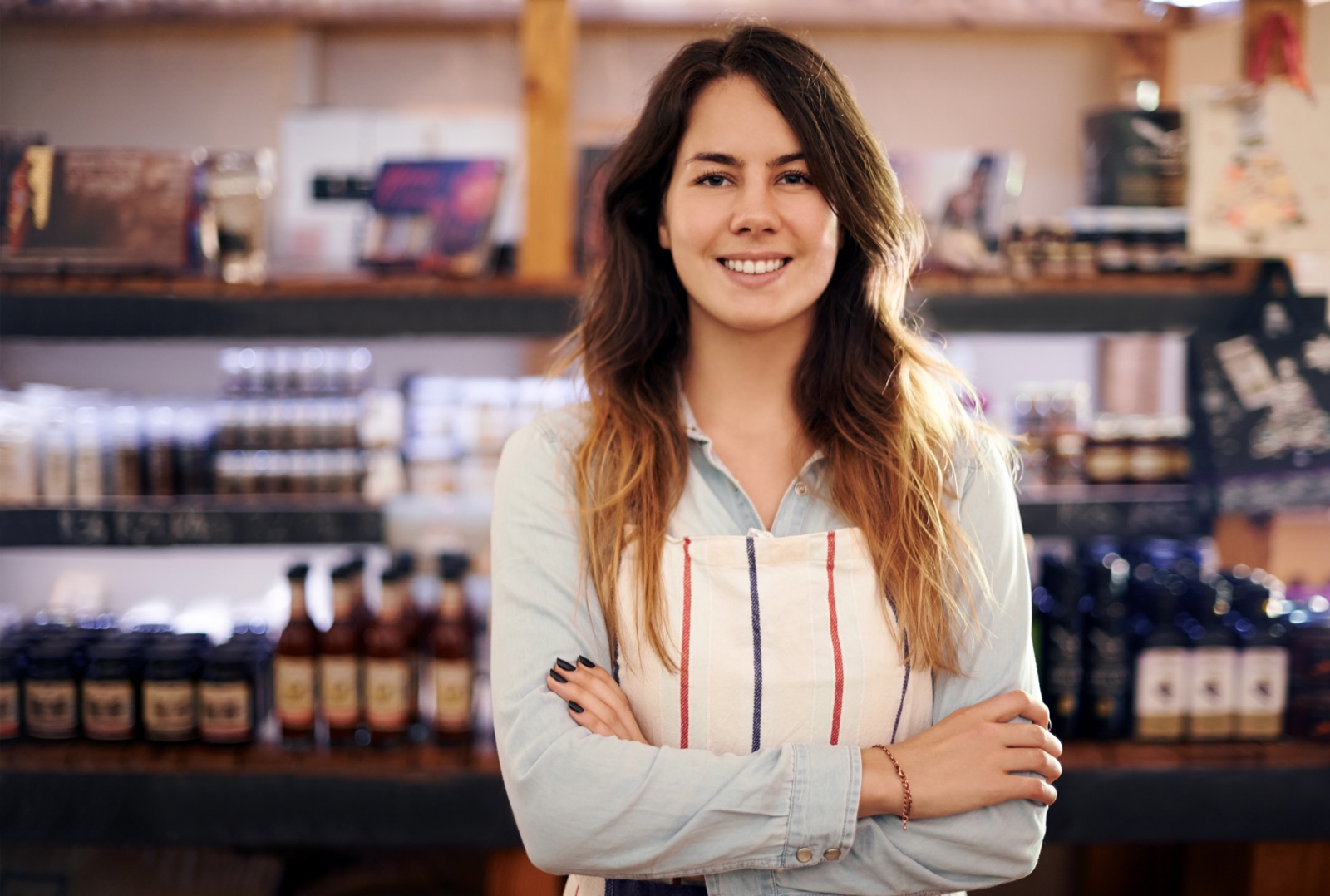 A confident small business owner standing in her shop