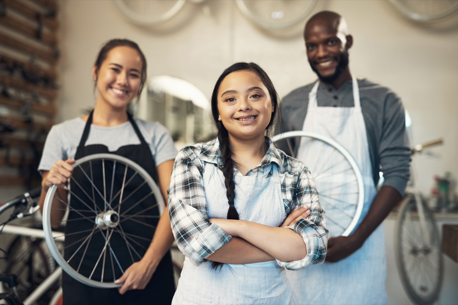 Three bike shop colleagues working together