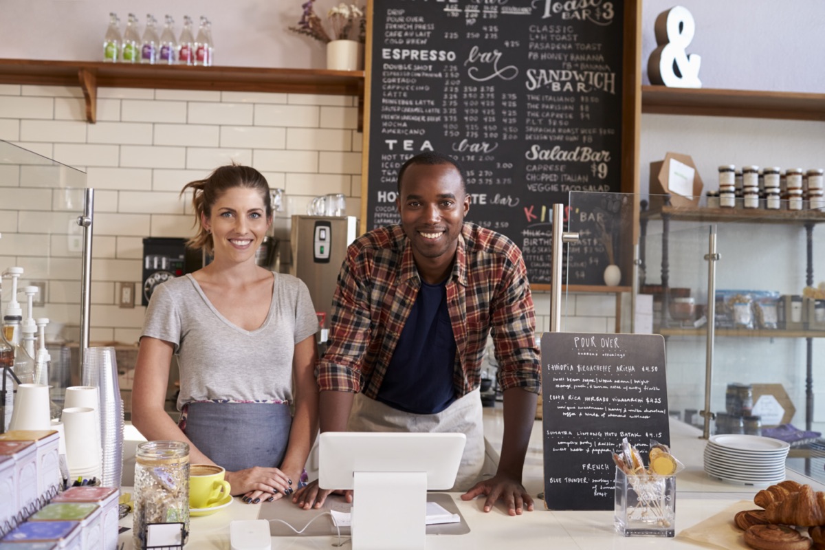 Two co-owners standing behind their counter